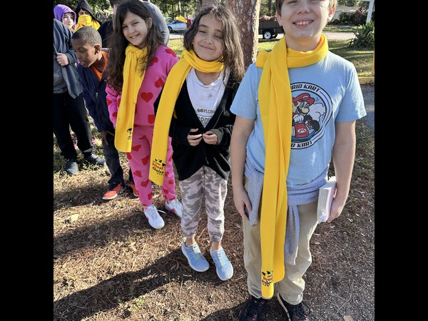 Agape Christian School students wearing yellow scarfs