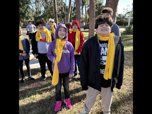 Agape Christian School students wearing yellow scarfs